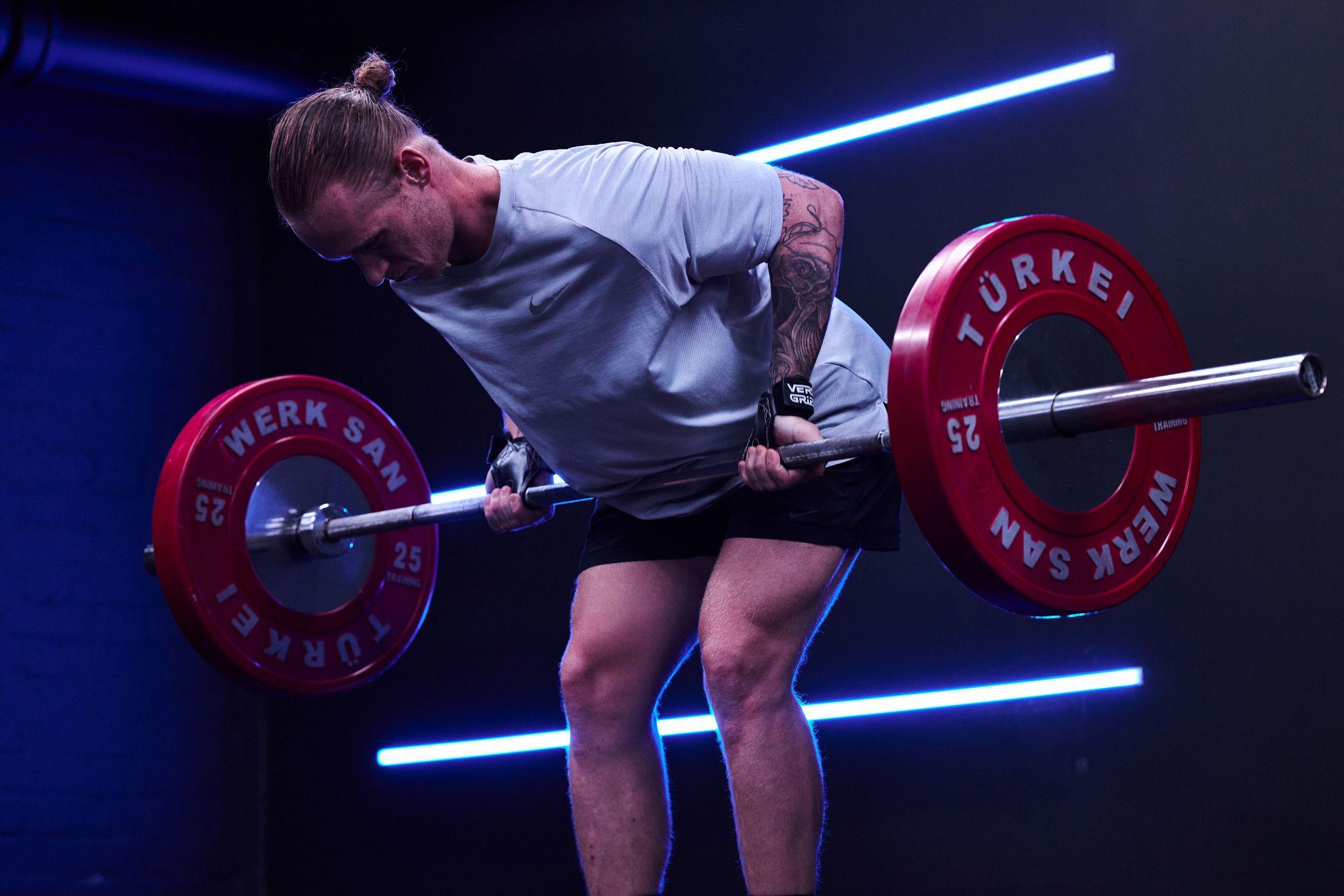 Male model weightlifting using Versa Gripps